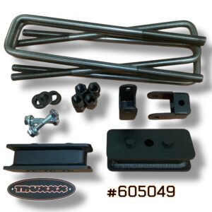 Detailed view of Truxxx heavy-duty 2-inch rear lift blocks and shock brackets for Ram 3500/4500/5500 DRW. Showcases the fully-welded 1/4-inch plate steel construction and durable black finish designed for emergency vehicle grade reliability and commercial use.