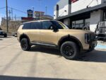 A leveled 2027 Kia Telluride SUV parked on a flat surface highlighting the increased ground clearance from the 306031 lift kit.