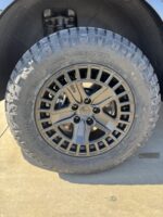Close up of an All Terrain tire on a 2027 Kia Telluride showcasing the increased wheel well gap and tire clearance from the Truxxx 2.5 inch lift rotated.