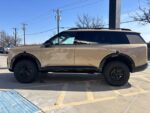Side profile of a 2027 Kia Telluride showing a perfectly level 2.5 inch lift with shock shaft extensions to maintain factory ride quality.